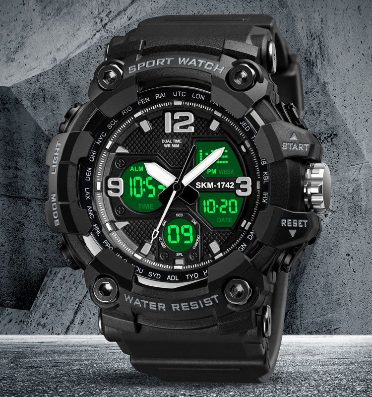 Shockproof Digital Chrono — black with lit display, styled concrete backdrop
