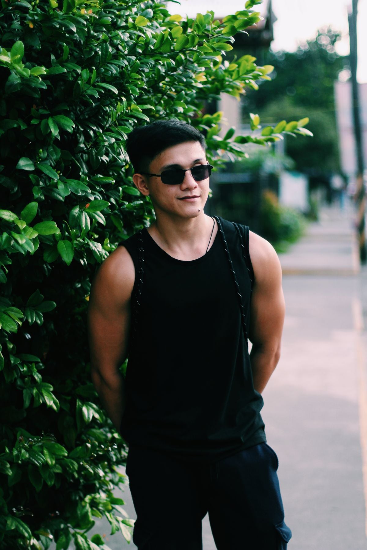 Black tank top, medium build, walking outdoors