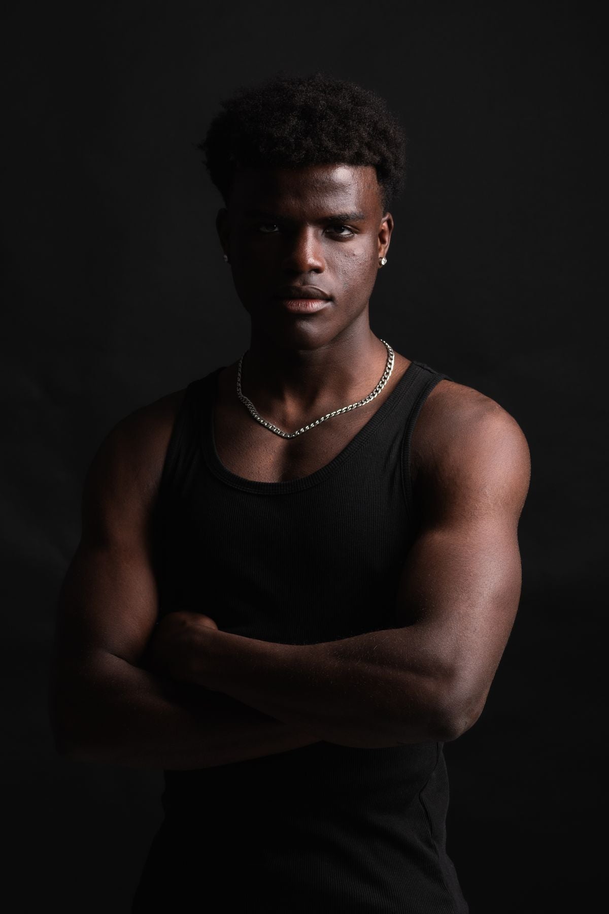 Black tank top, bigger build, photoshoot pose